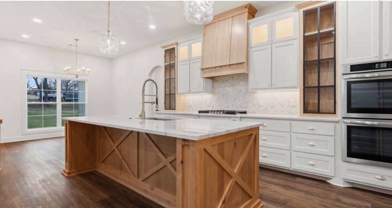 Custom kitchen with timber island and white cabinetry